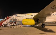 a plane with yellow engine and stairs