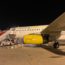 a plane with yellow engine and stairs