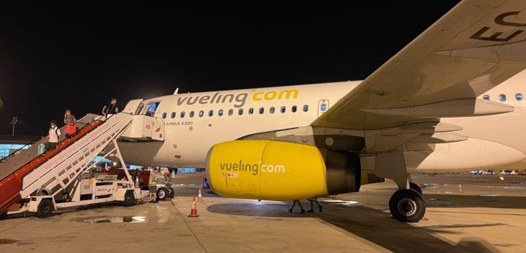 a plane with yellow engine and stairs