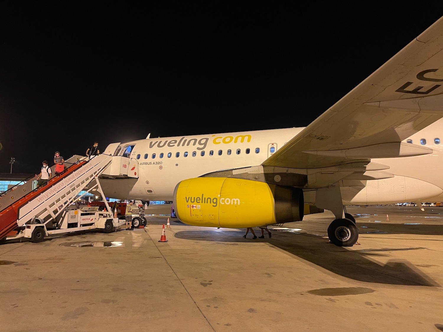 a plane with yellow engine and stairs