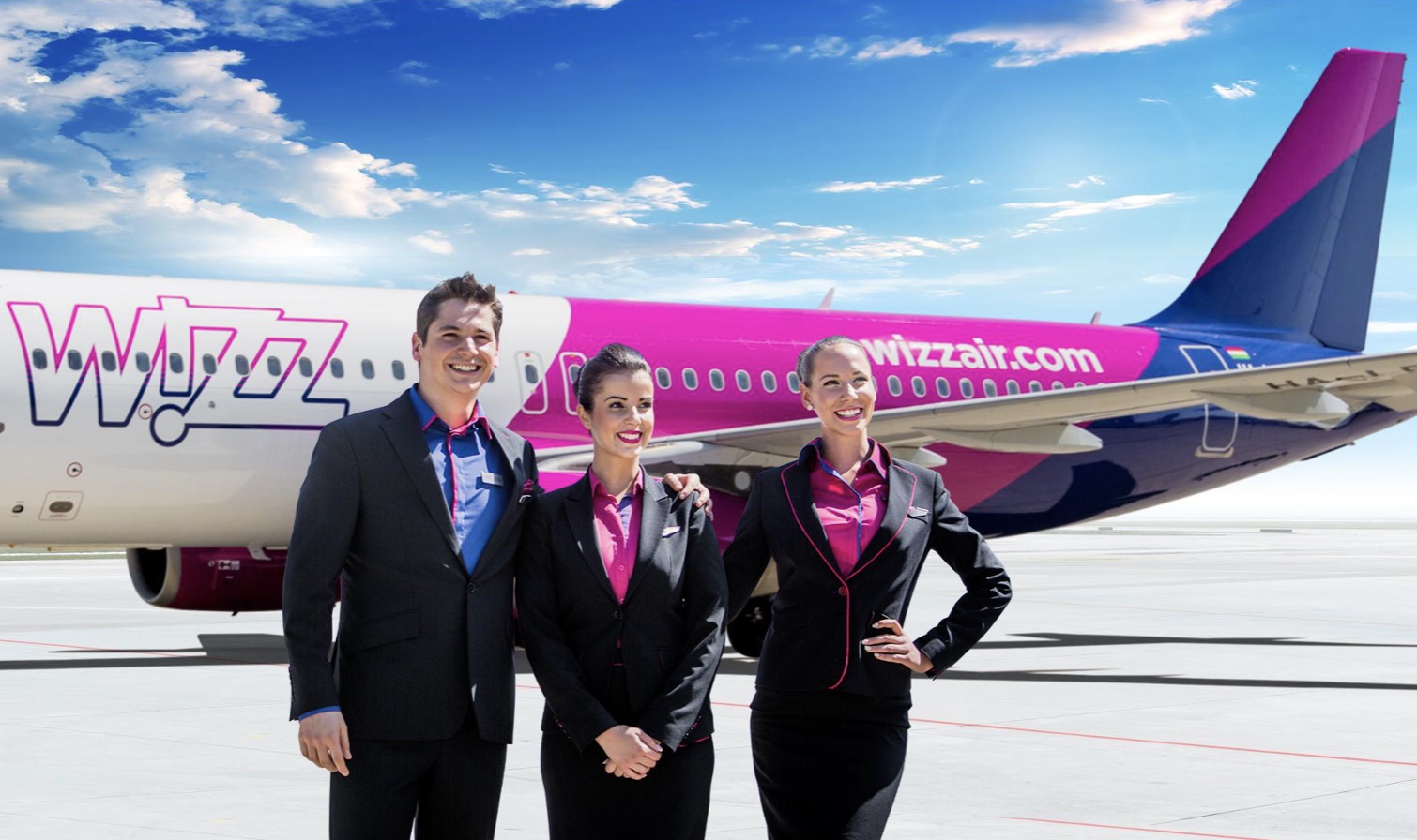 a group of people standing in front of a plane