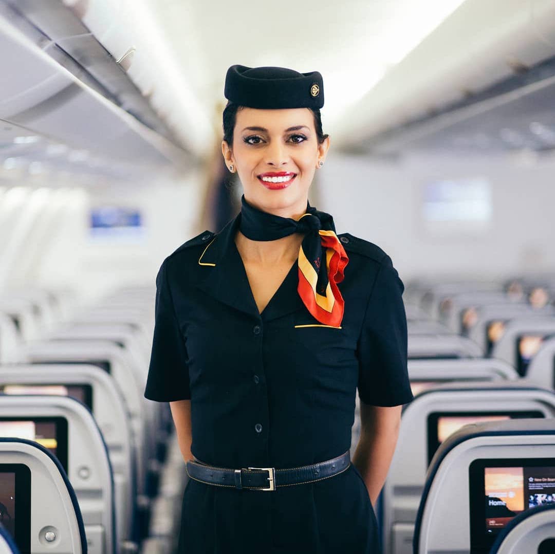 a woman in uniform standing in a row of rows of seats