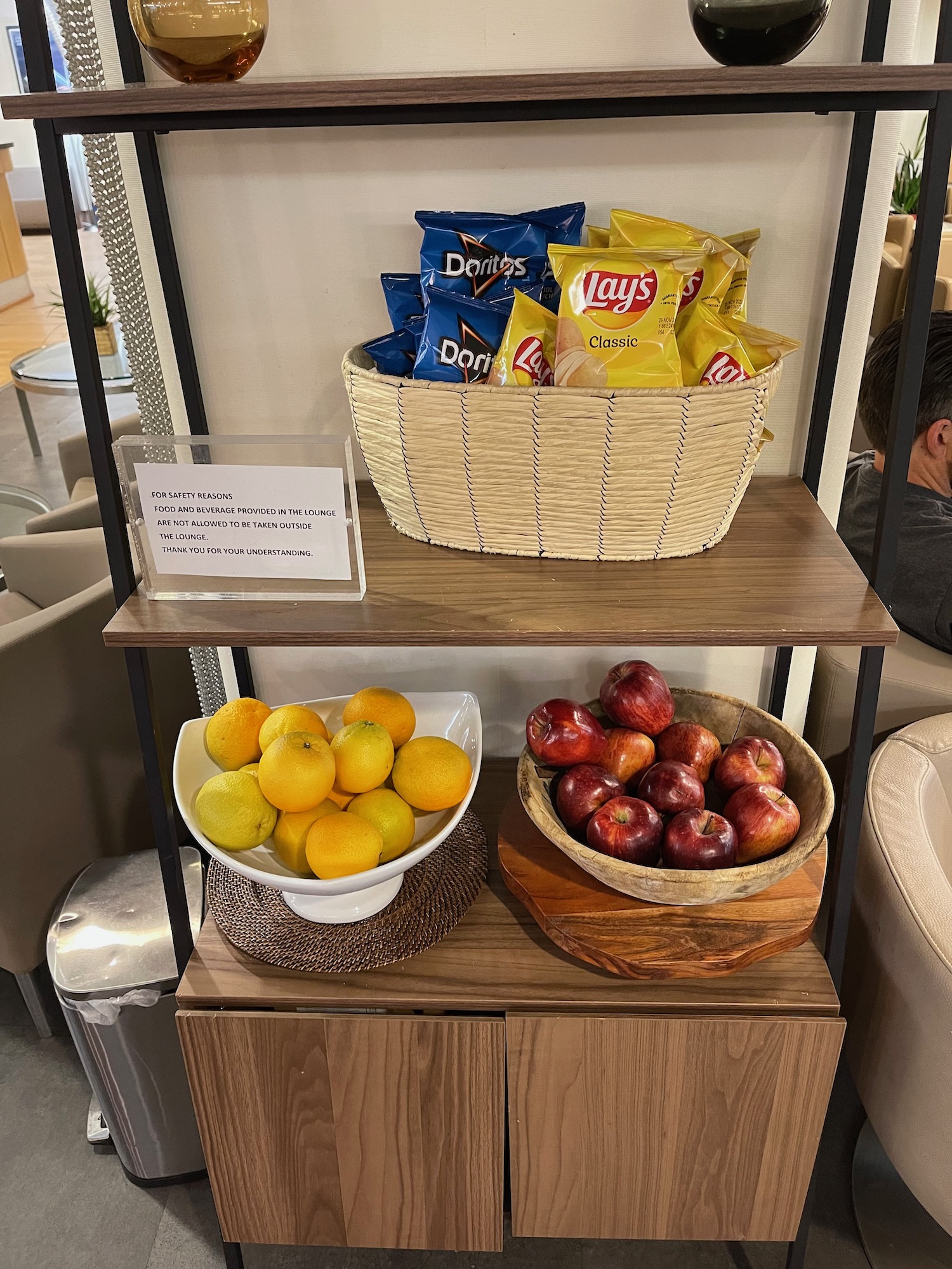 a shelf with fruit and chips on it