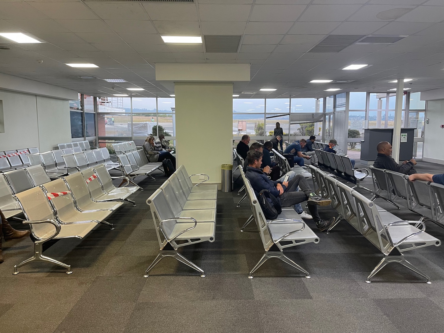 a group of people sitting in chairs in a waiting room