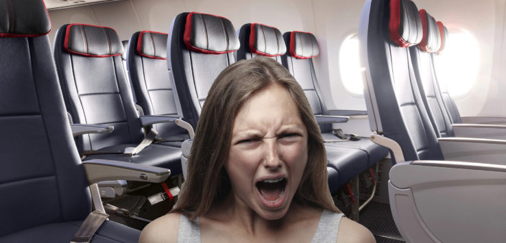 a woman in an airplane with her mouth open