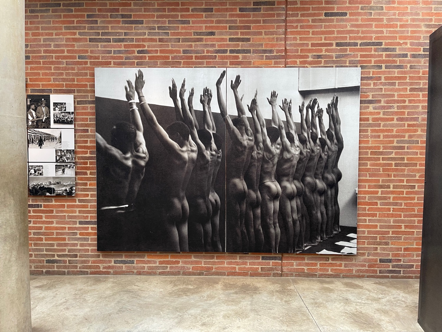 a large picture of naked men raising their hands