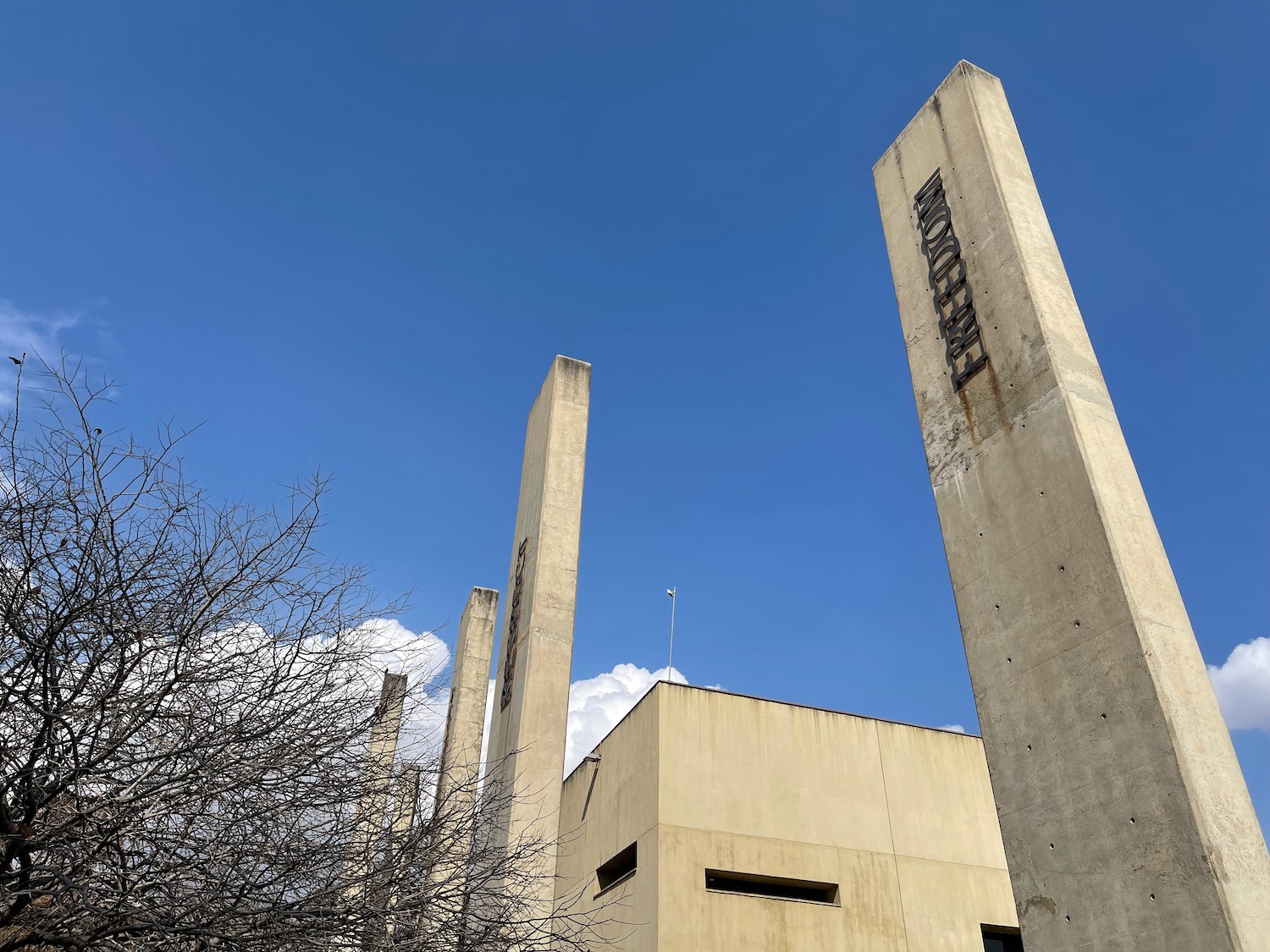 a tall concrete building with multiple pillars