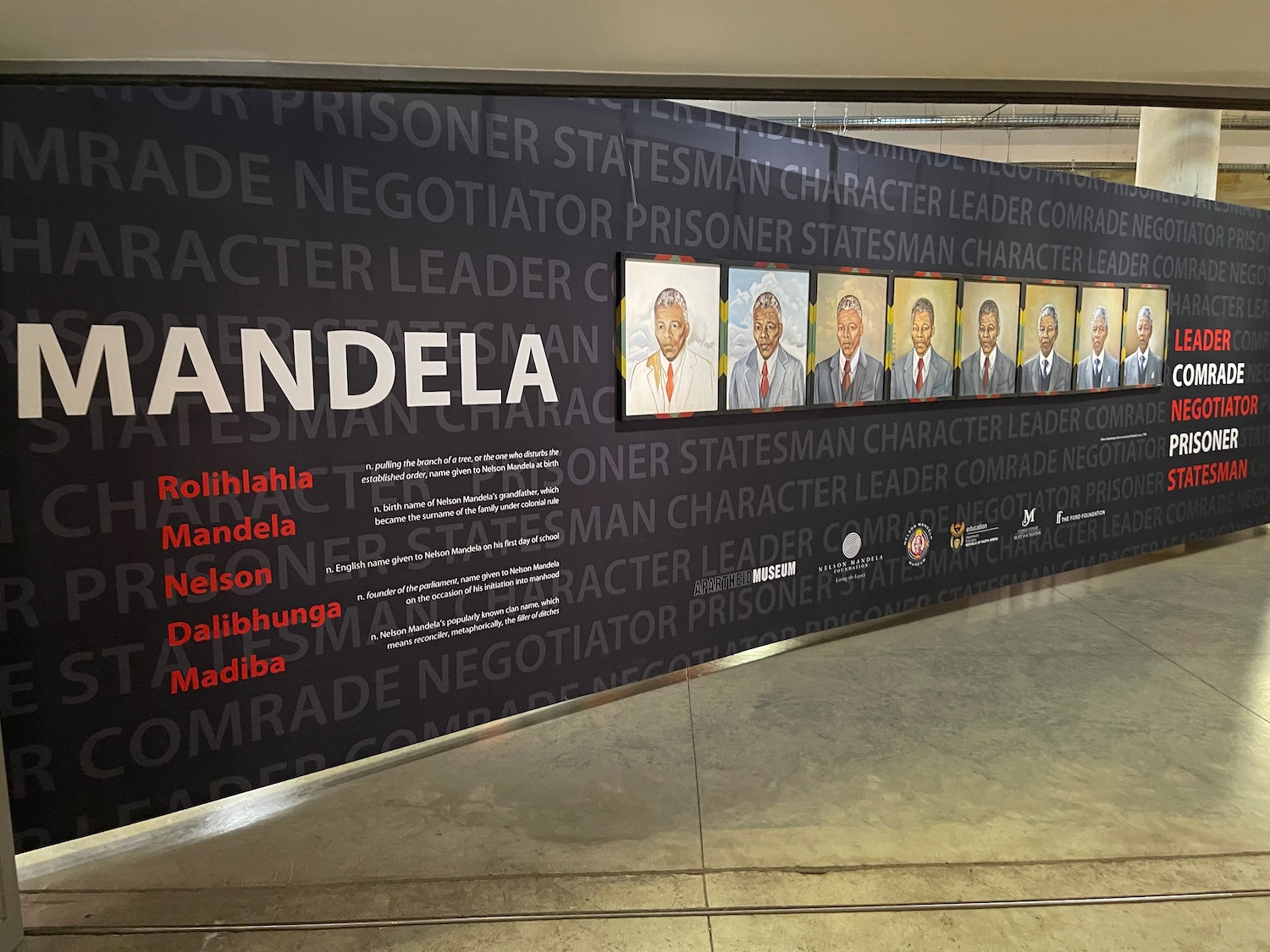 a wall with a group of portraits of men