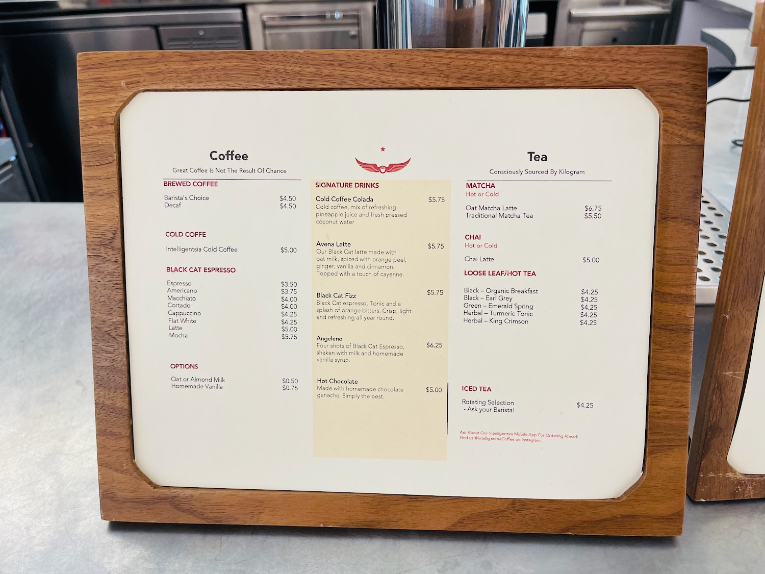 a menu board with a wood frame