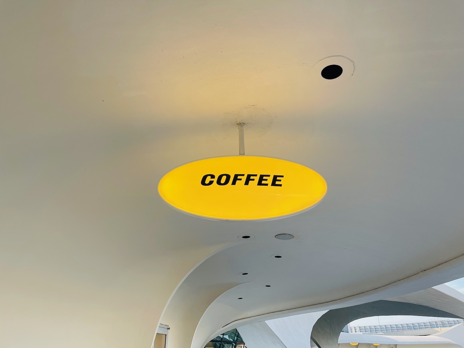a yellow sign on a ceiling