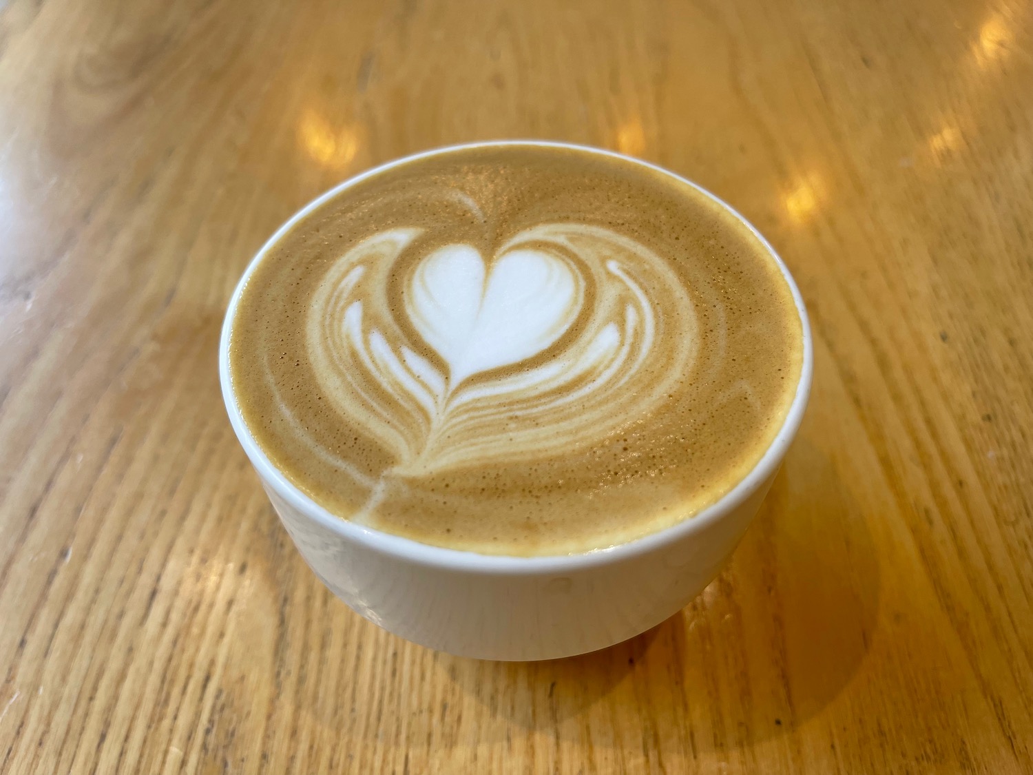 a cup of coffee with a heart in the foam