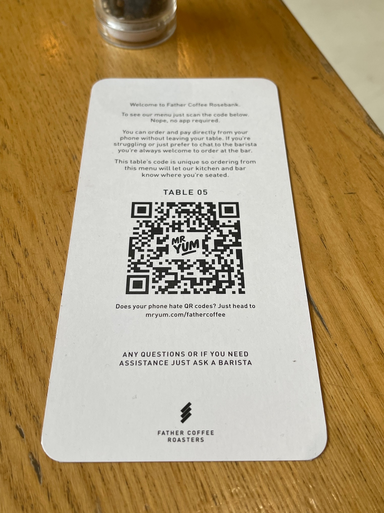 a paper card with qr code on a table