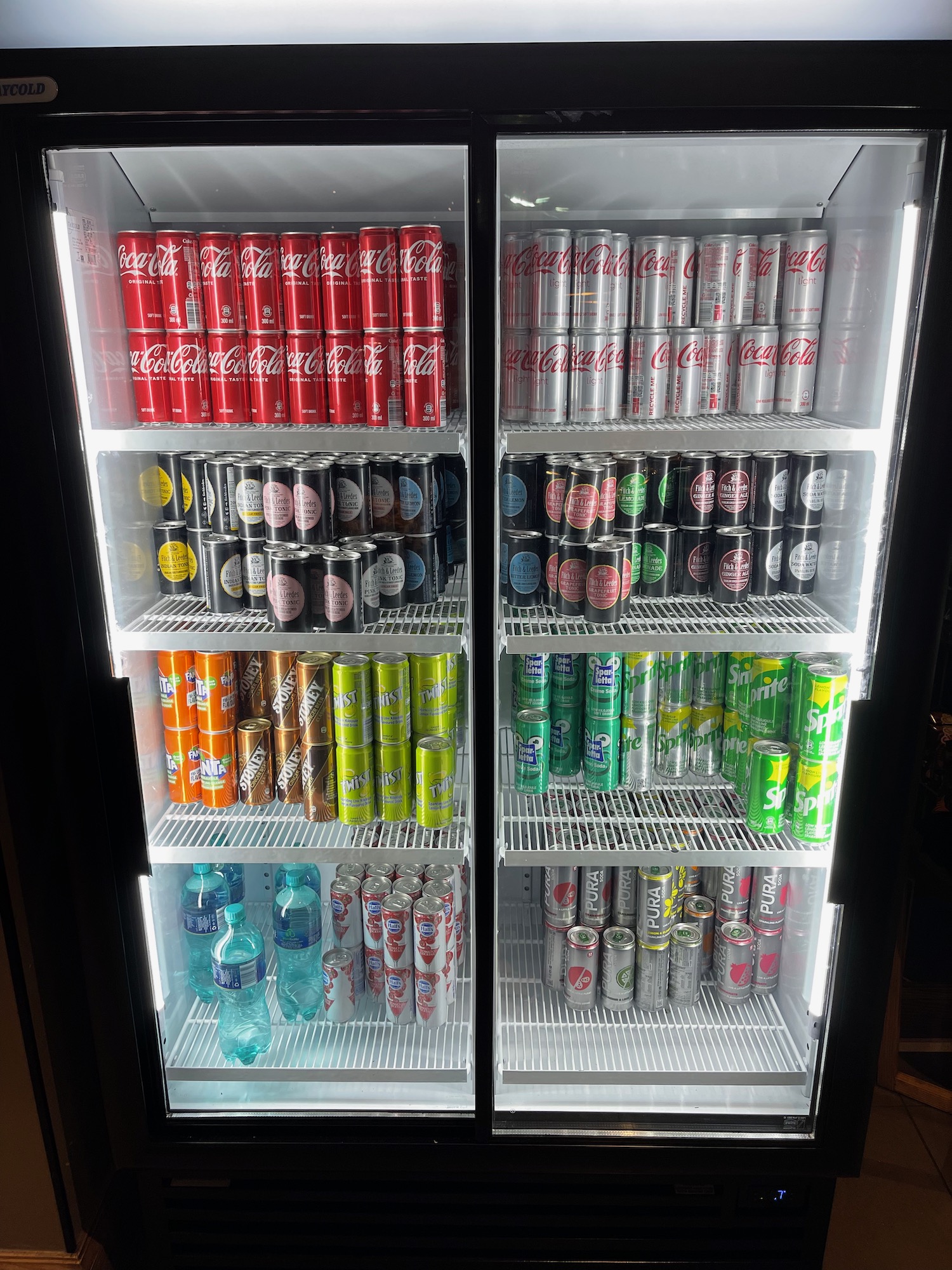 a refrigerator full of cans and soda