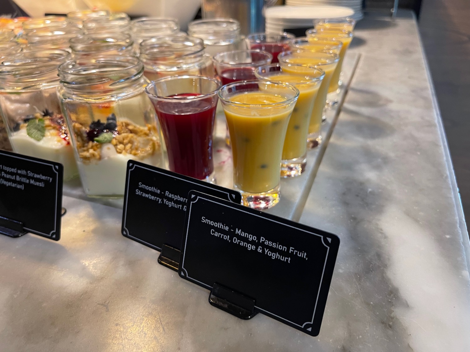 a row of glasses of fruit and yogurt