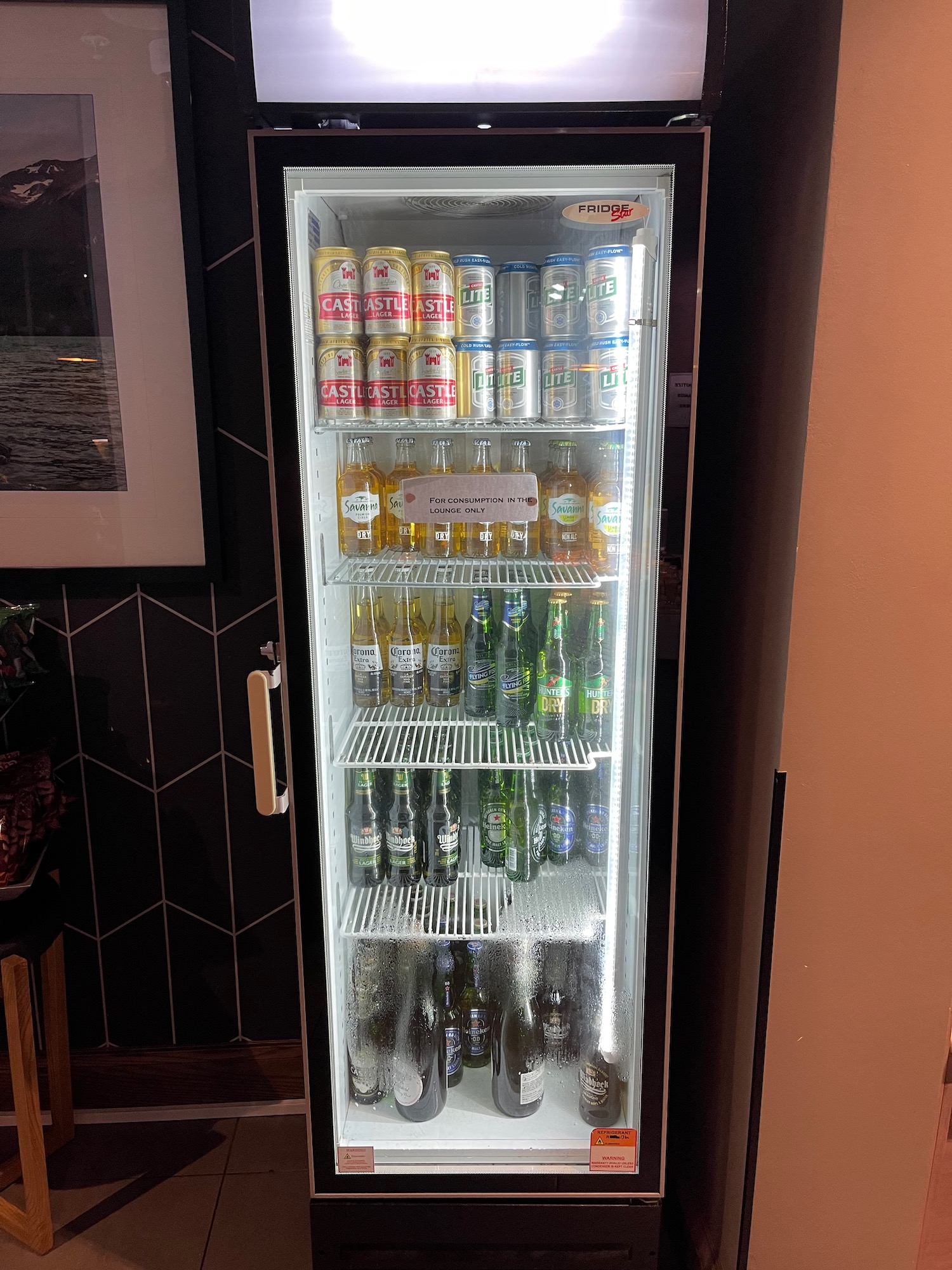 a refrigerator full of beer and cans