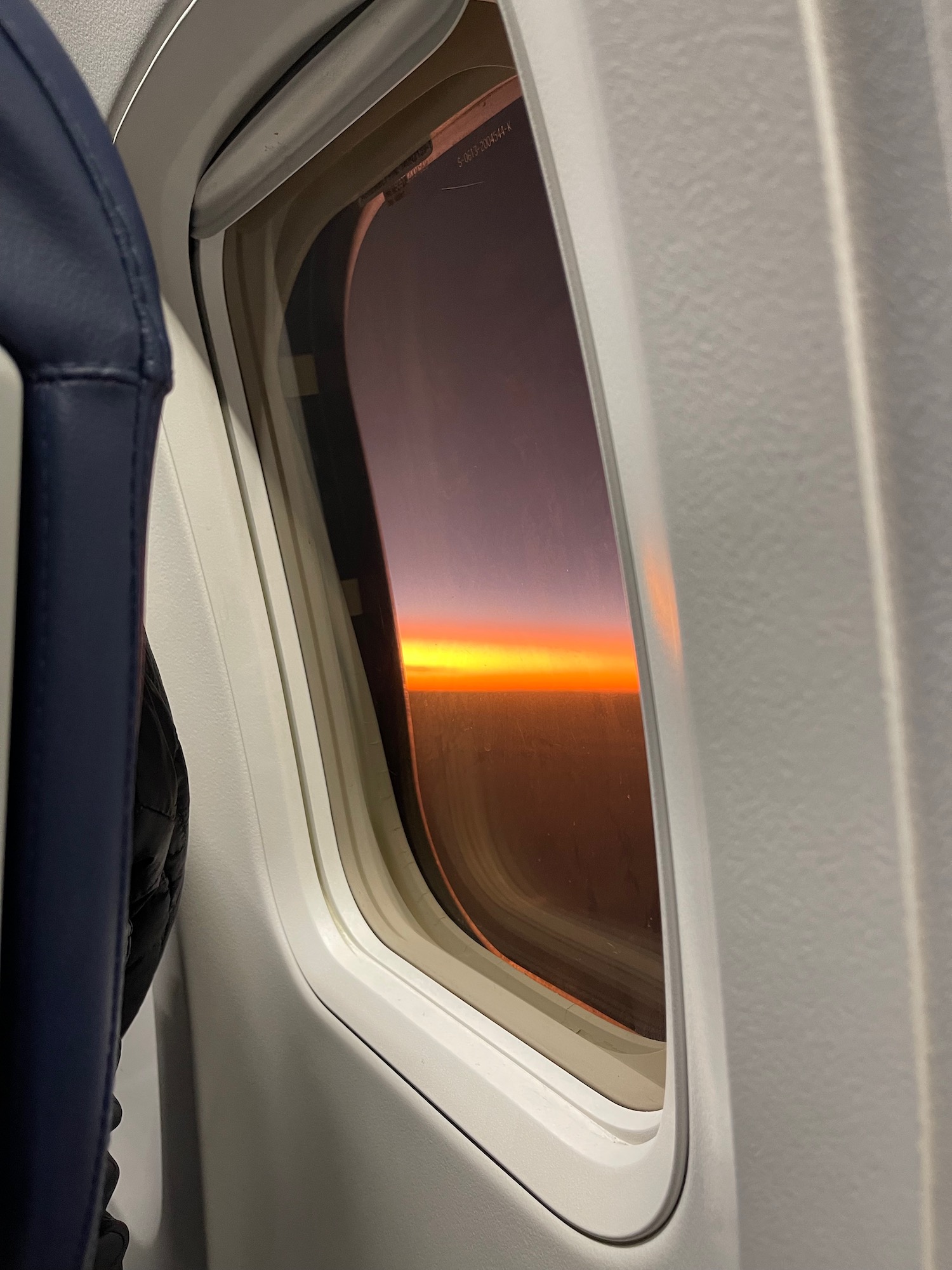 a window with a sunset in the background