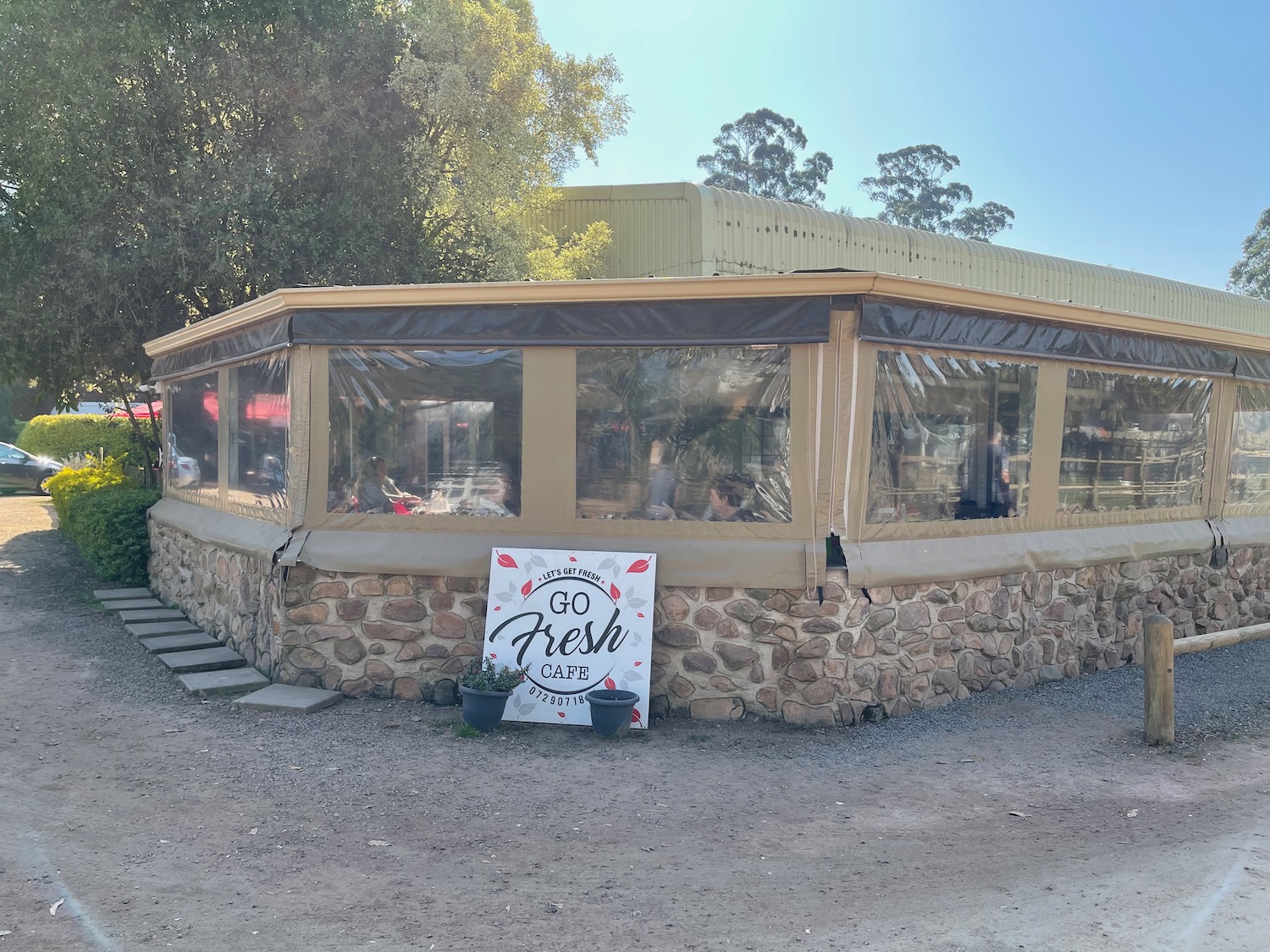 a building with a stone wall and a sign