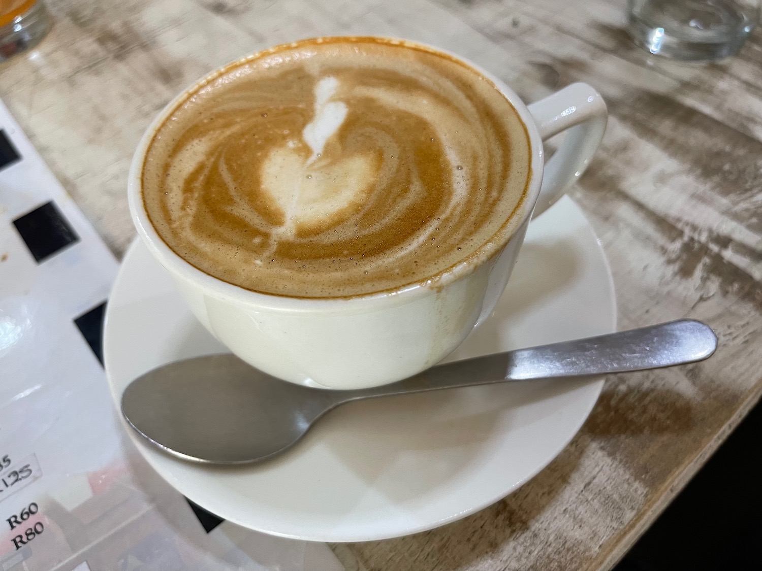 a cup of coffee with a heart shaped foam