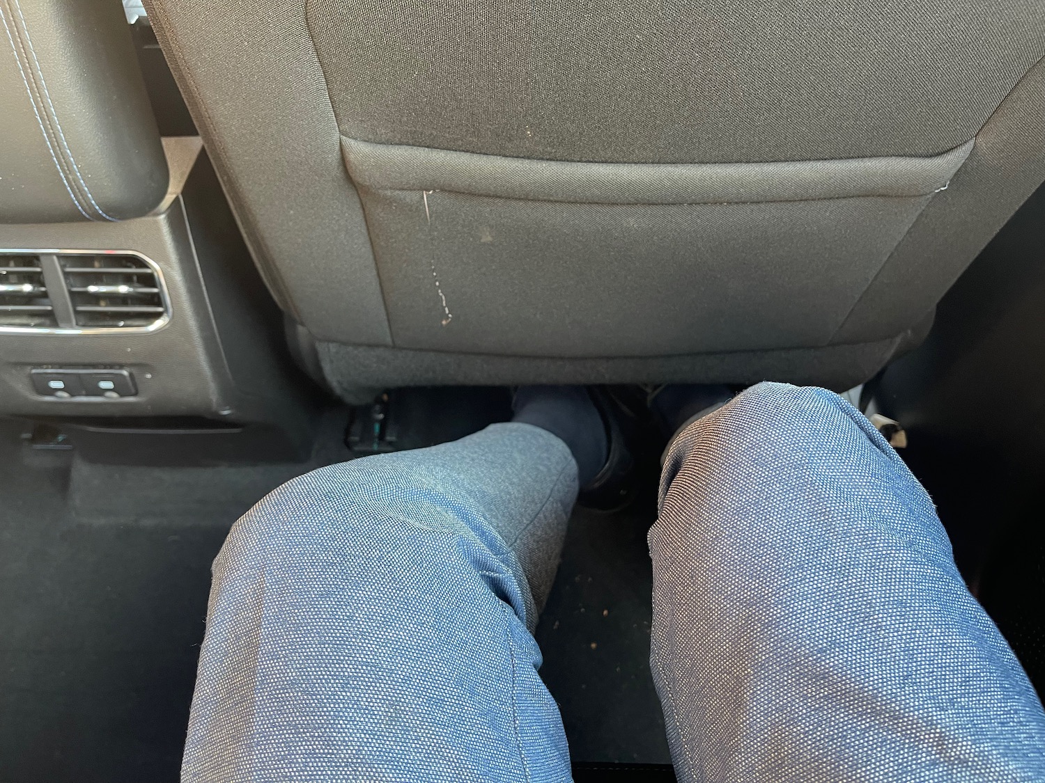 a person's legs in a car