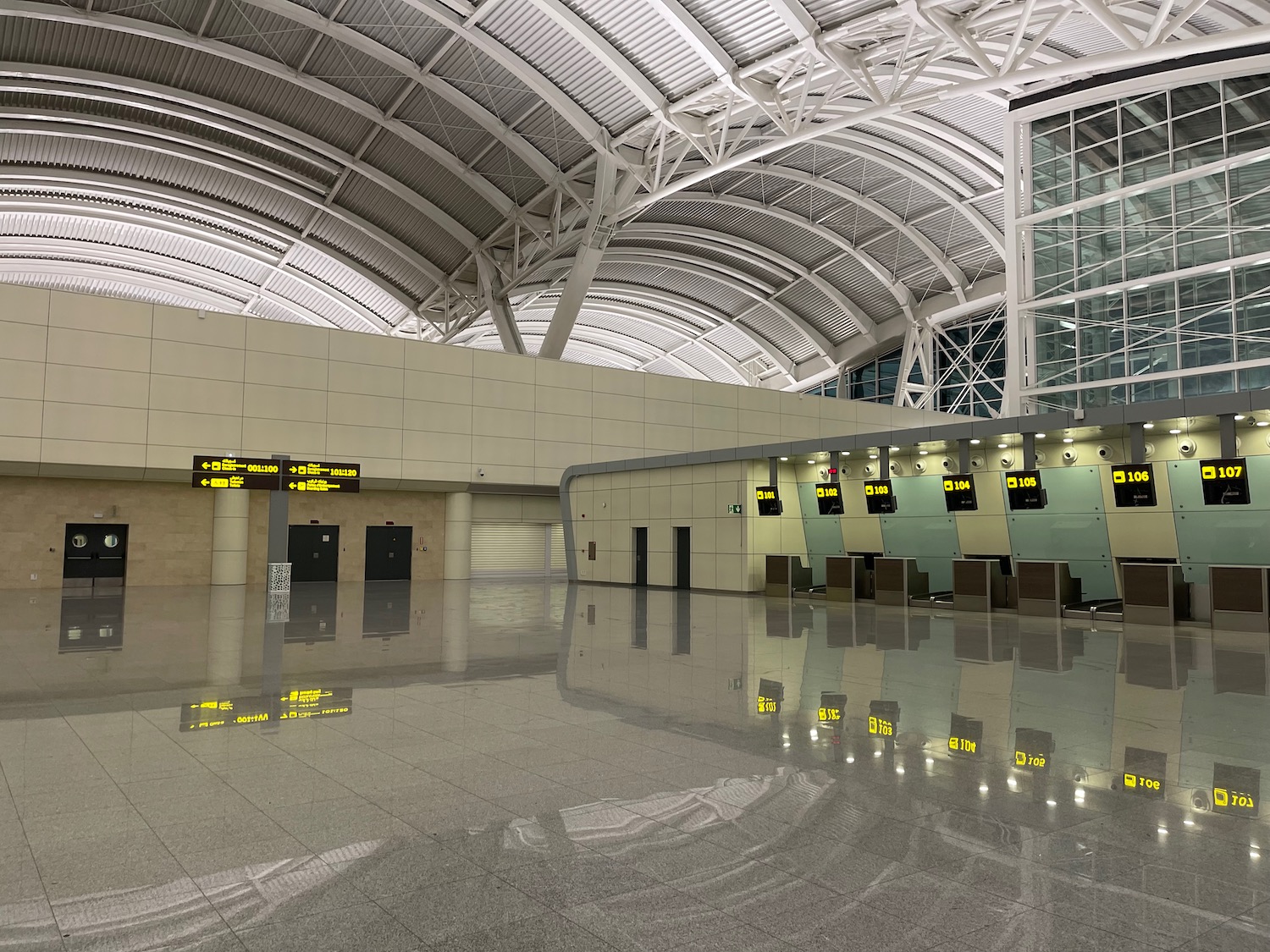 a large empty airport with a glass roof