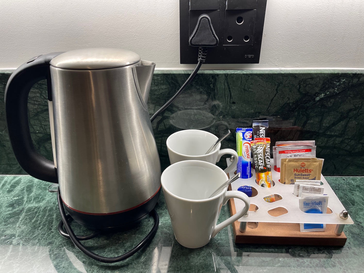 a coffee maker and cups on a counter