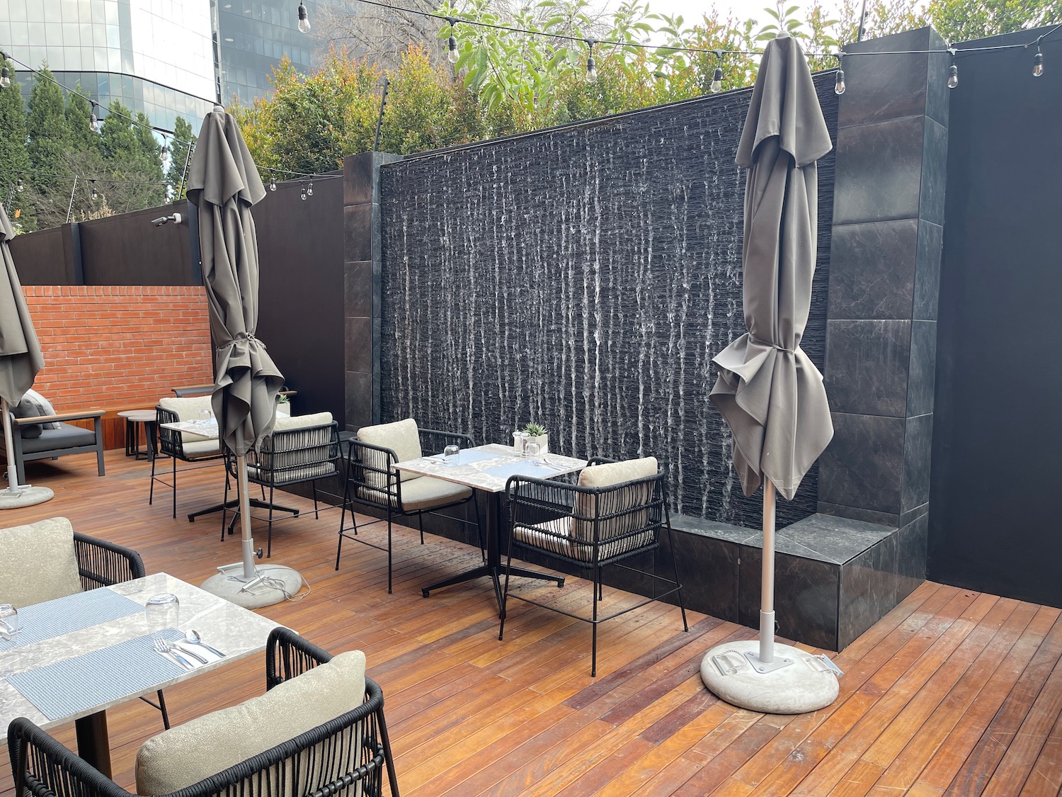 a patio with tables and chairs and umbrellas