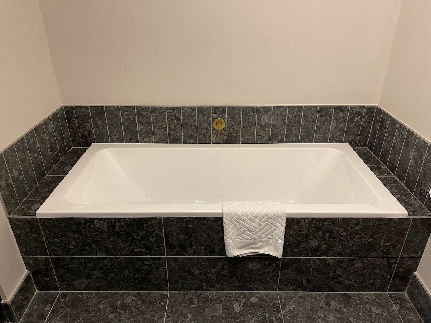 a bathtub with a towel on the side
