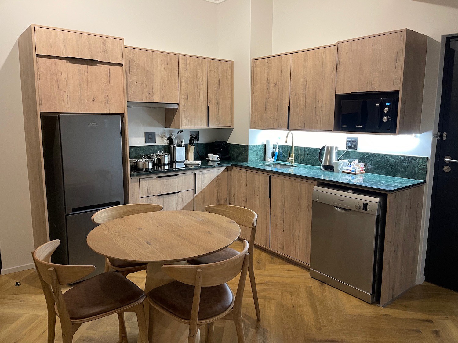 a kitchen with wooden cabinets and a table