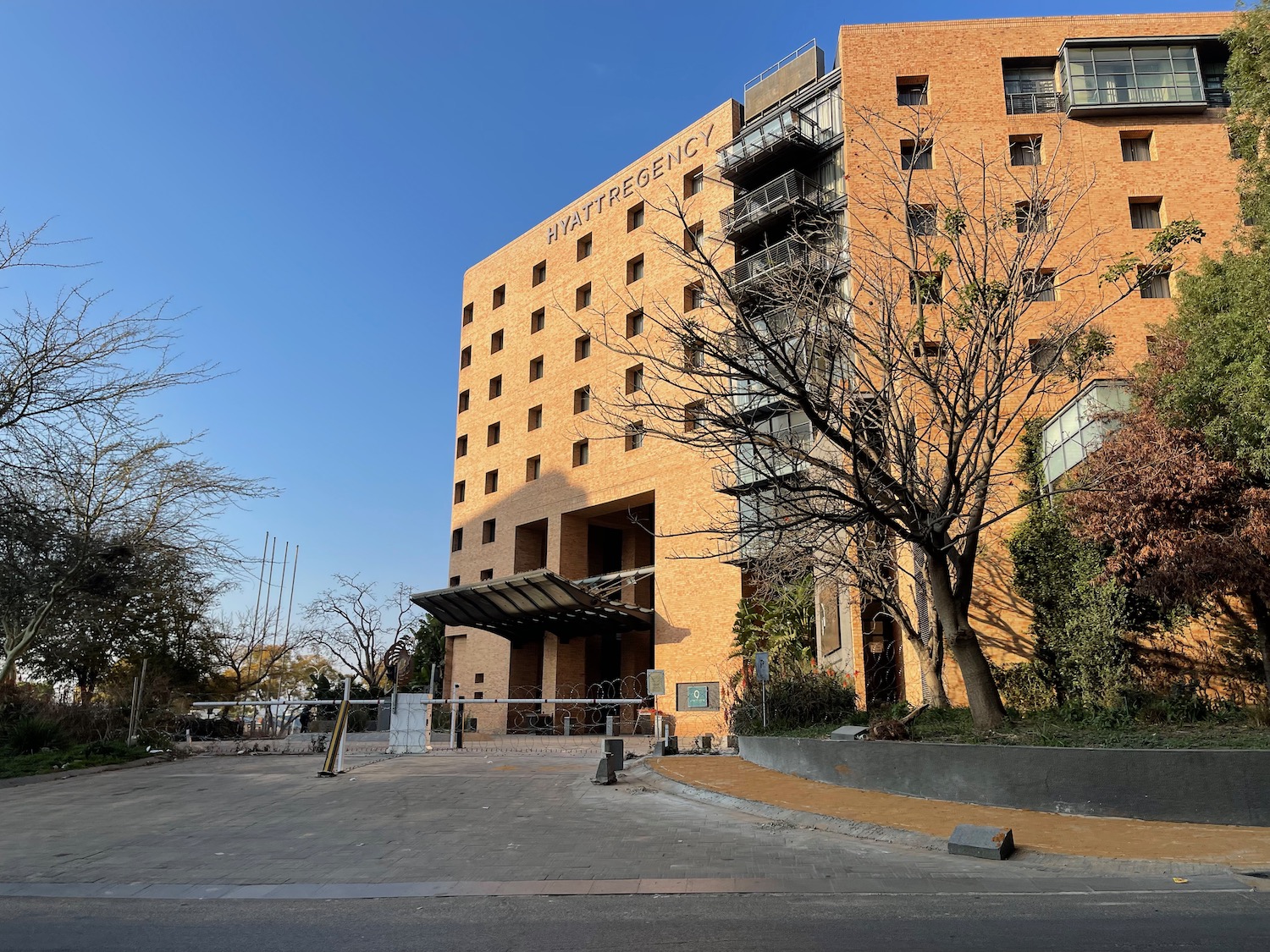 a building with trees and a road