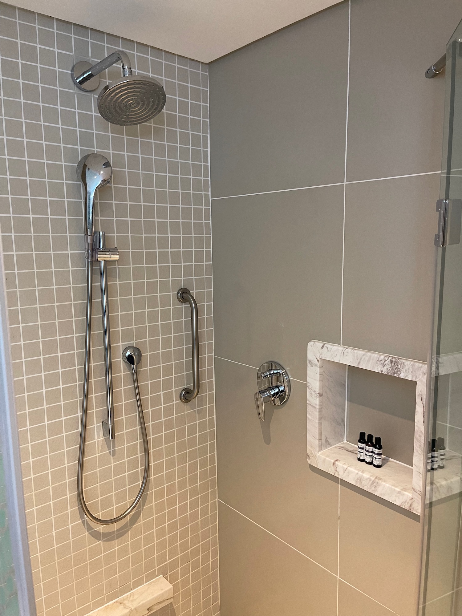 a shower with a shower head and a shower head