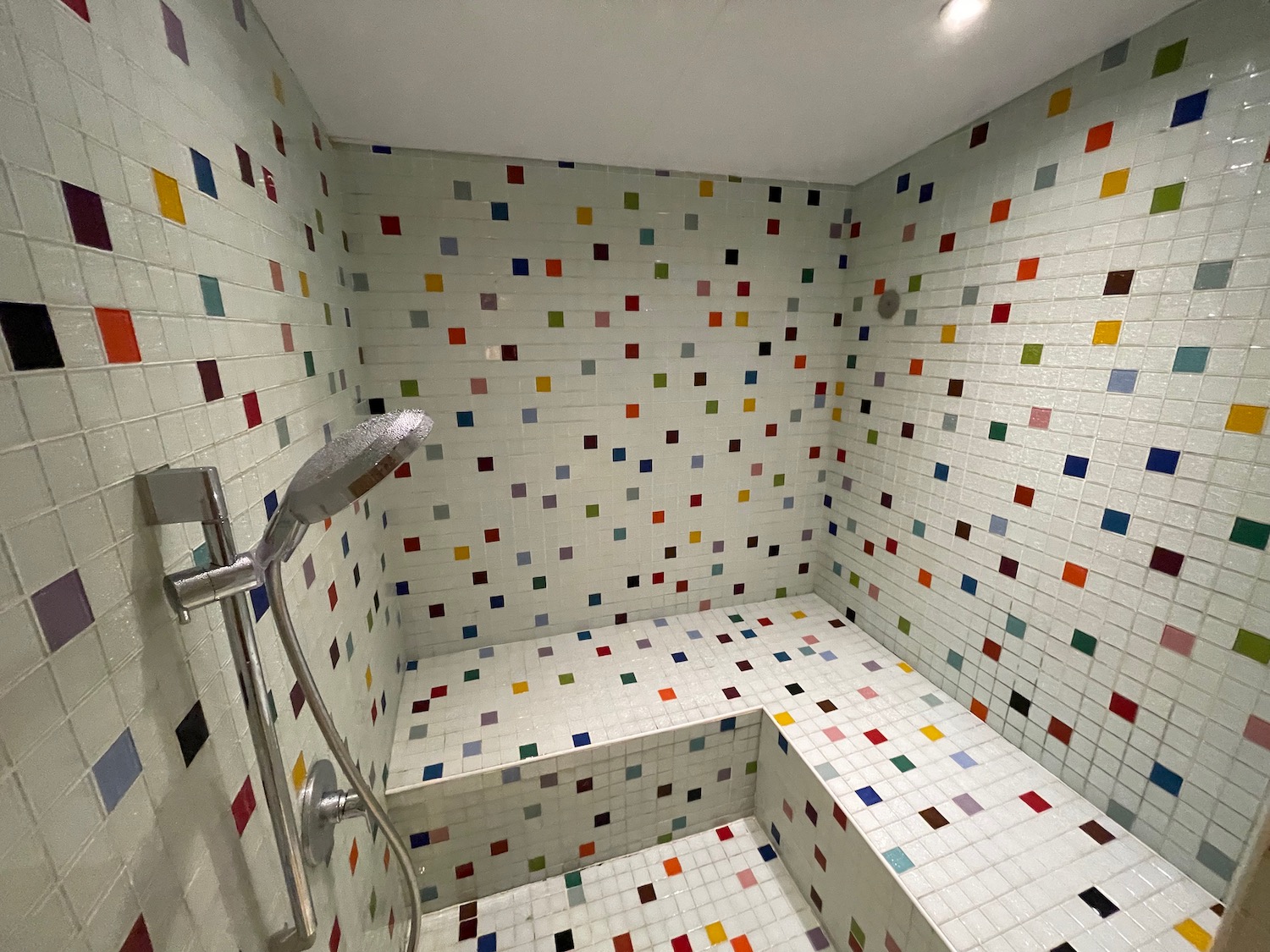 a shower with colorful tiles