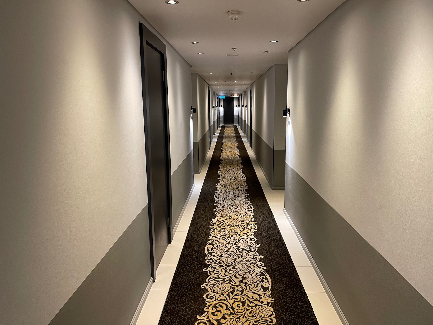 a long hallway with a carpeted rug