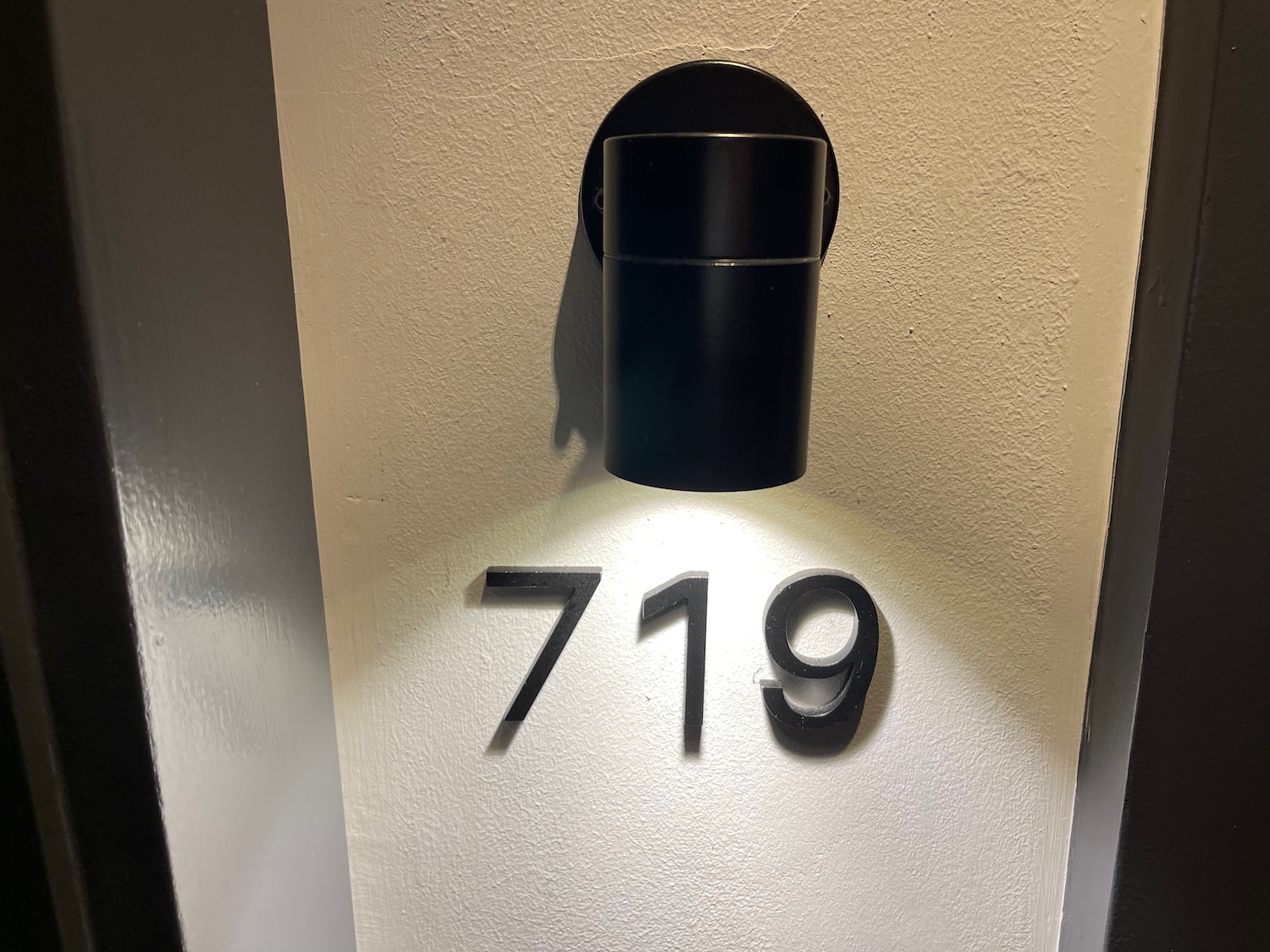a black light fixture with numbers on a white wall