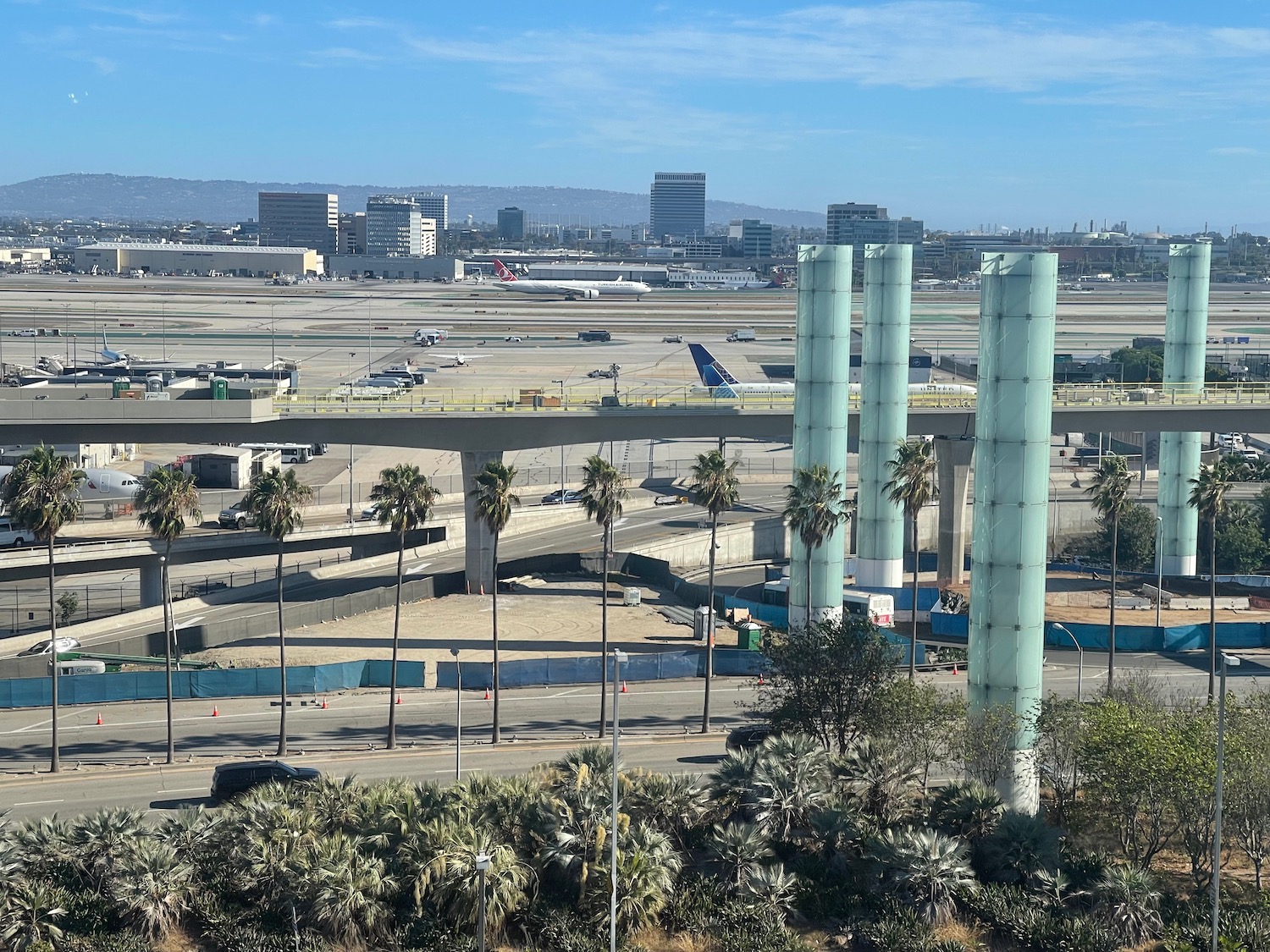 an airport with many tall towers and trees