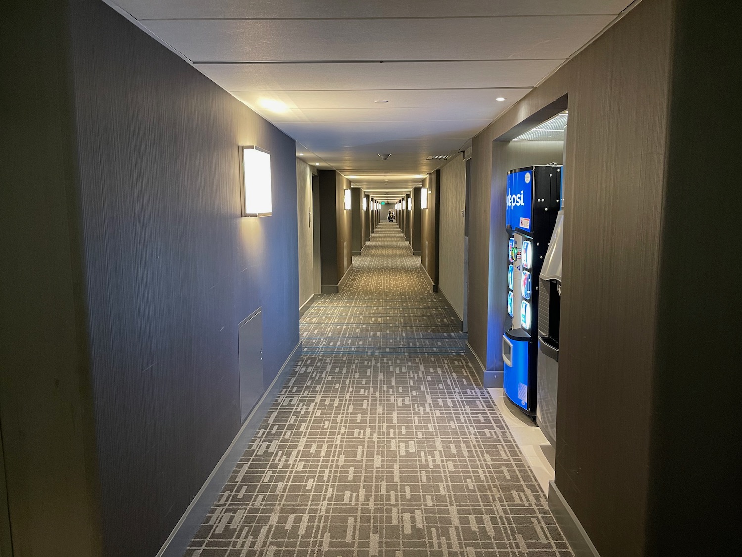 a hallway with a carpeted floor and vending machines