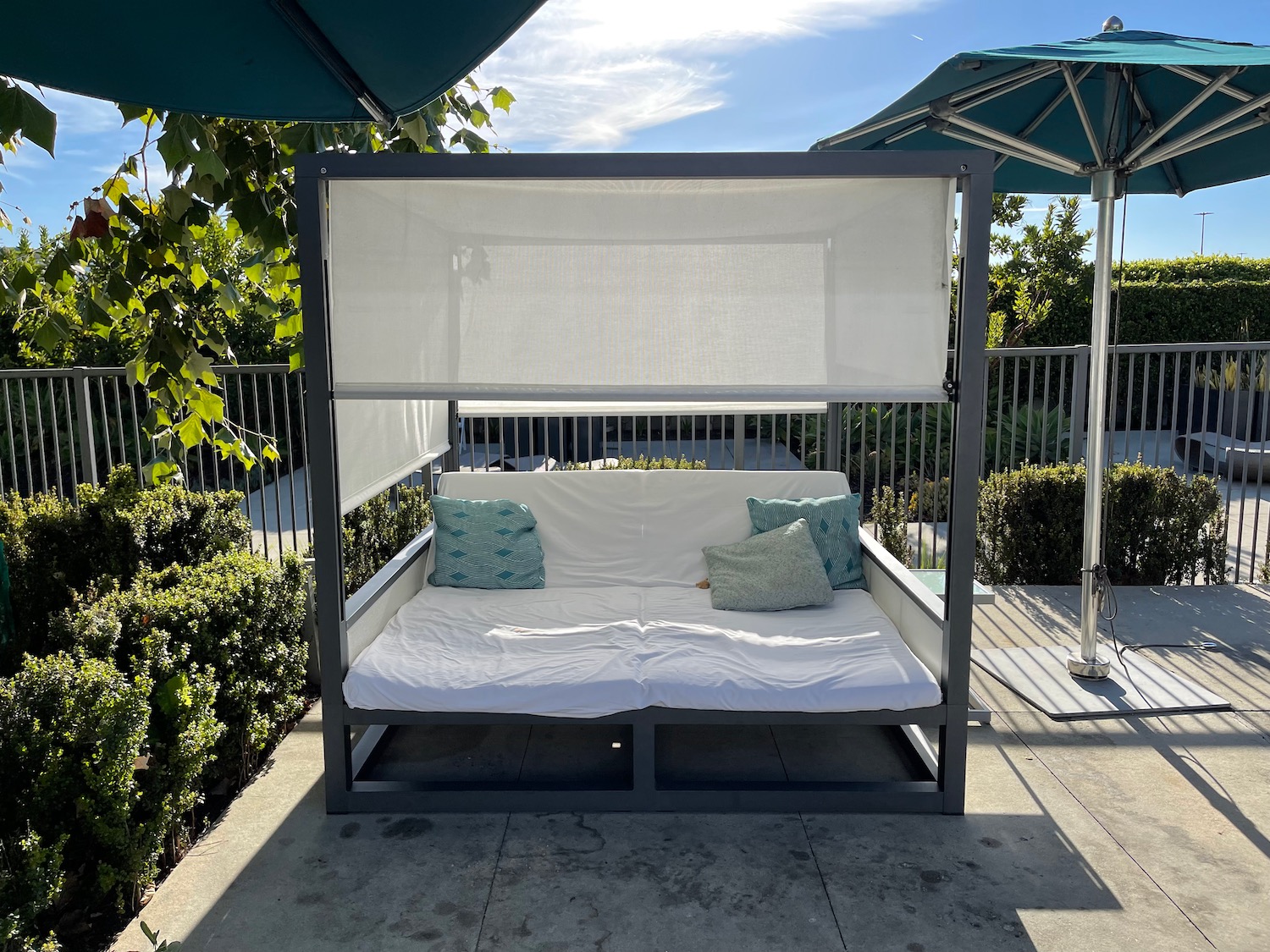 a white couch with pillows on a patio