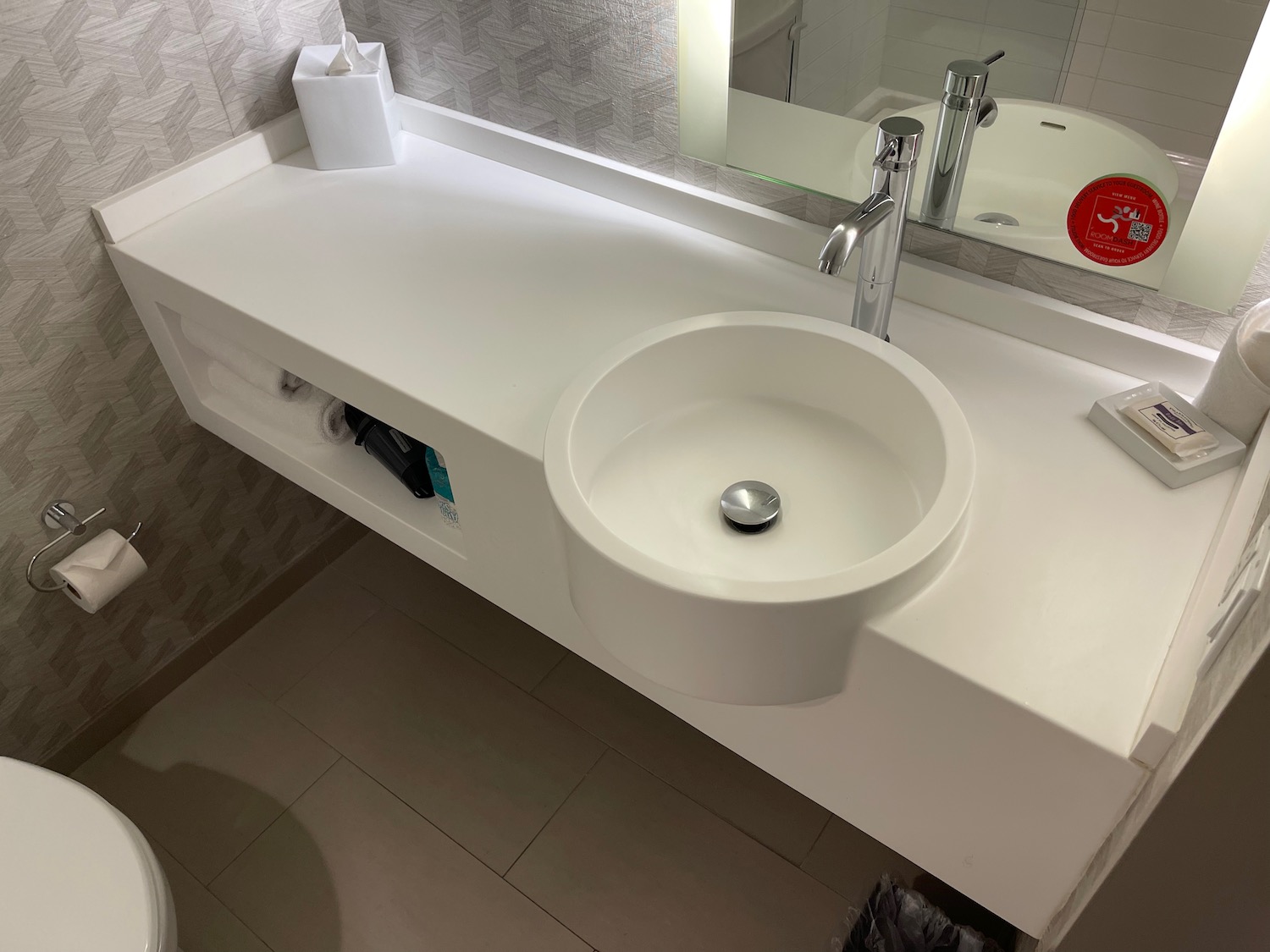 a white sink with a mirror