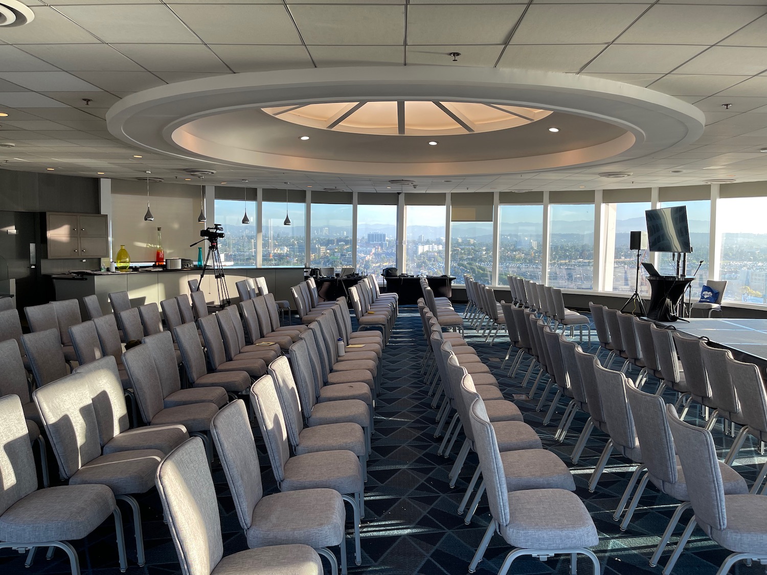 a room with many chairs and a large circular ceiling