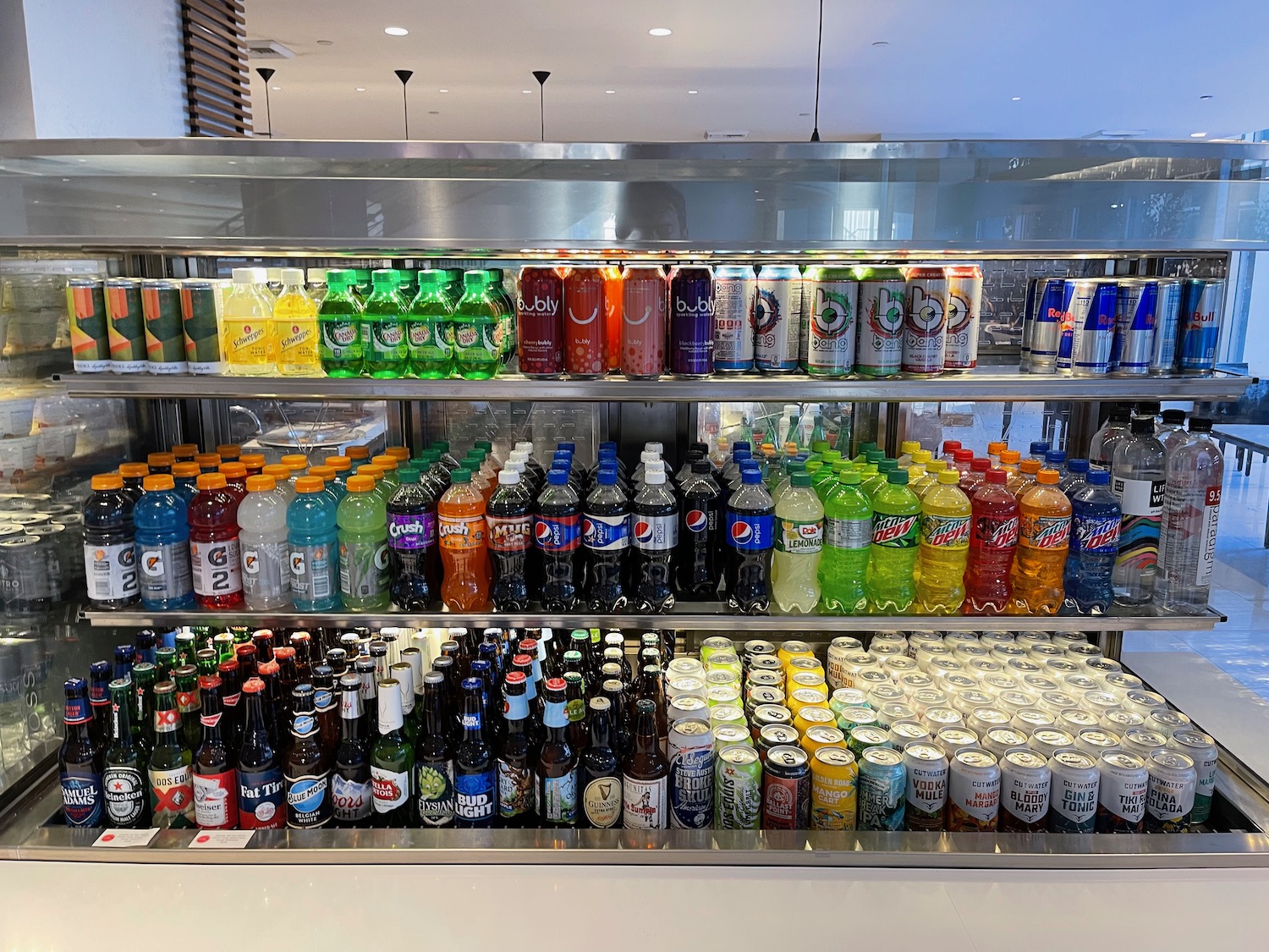 a shelf of soda and soft drinks