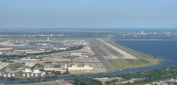 an aerial view of a runway and water