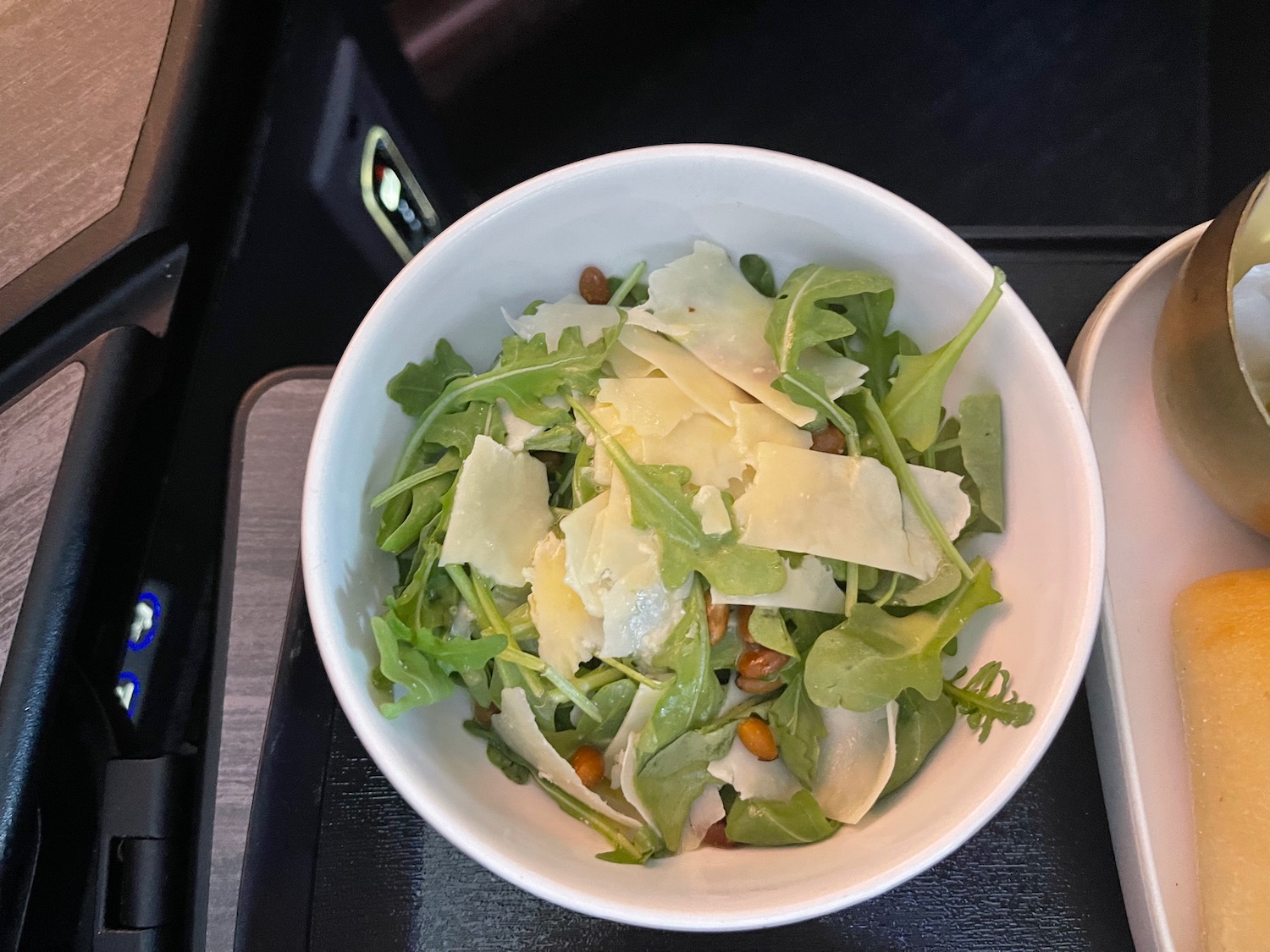 a bowl of salad with cheese and nuts