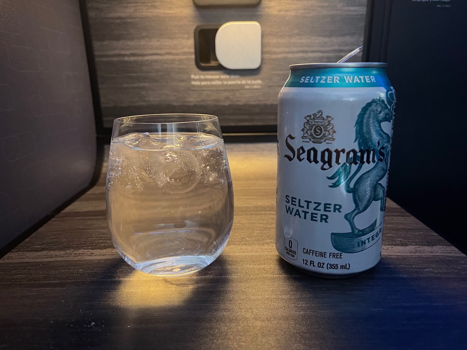 a can of water next to a glass of water