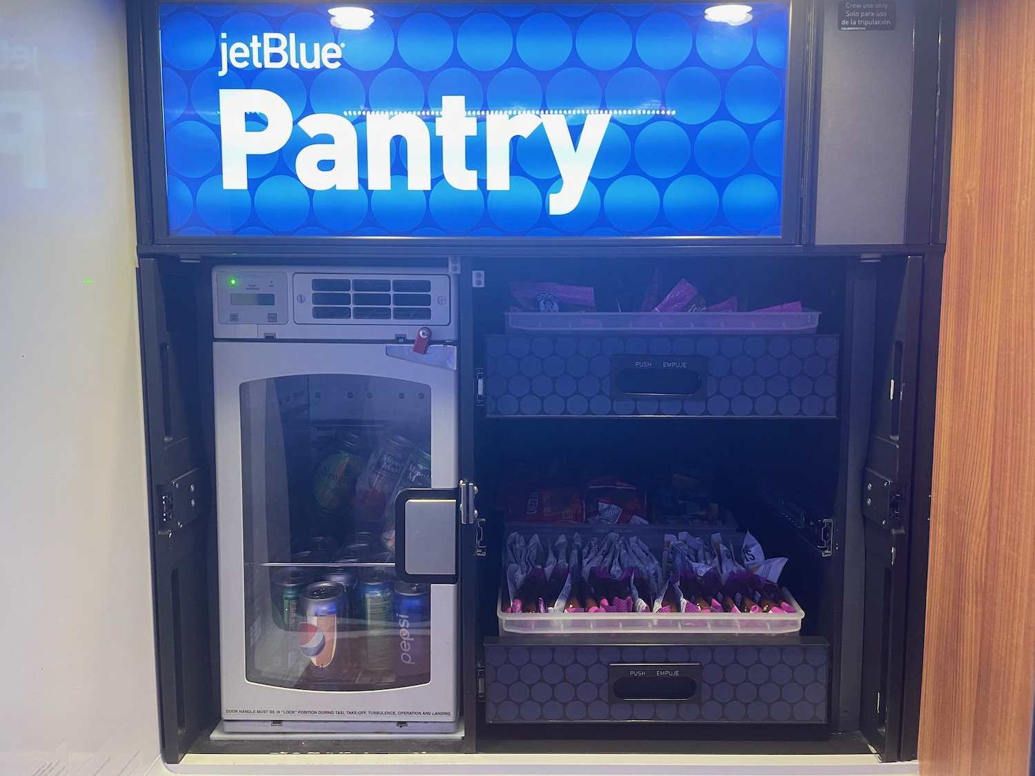 a refrigerator with a sign and a blue screen