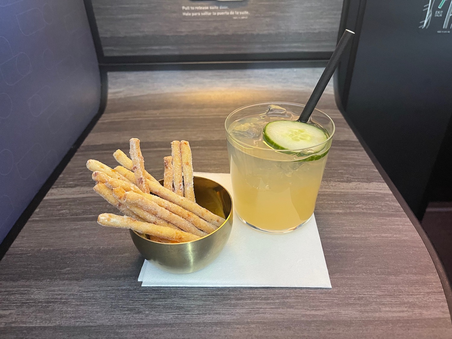 a bowl of bread sticks and a drink