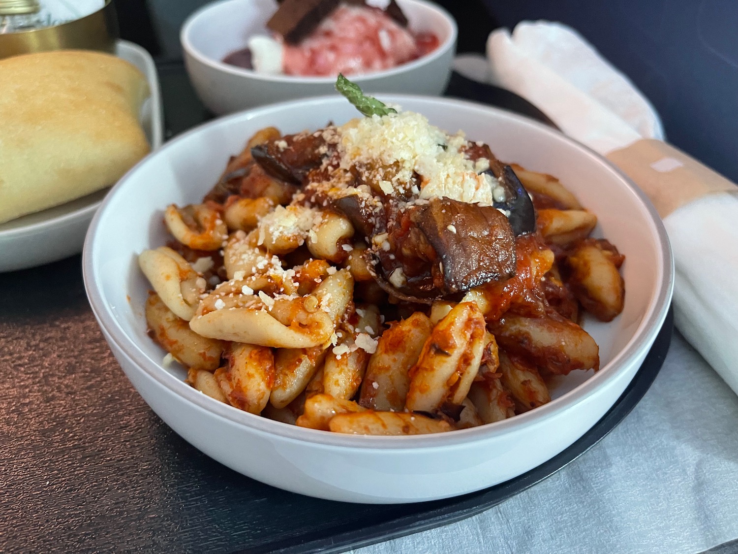 a bowl of pasta with cheese and mushrooms