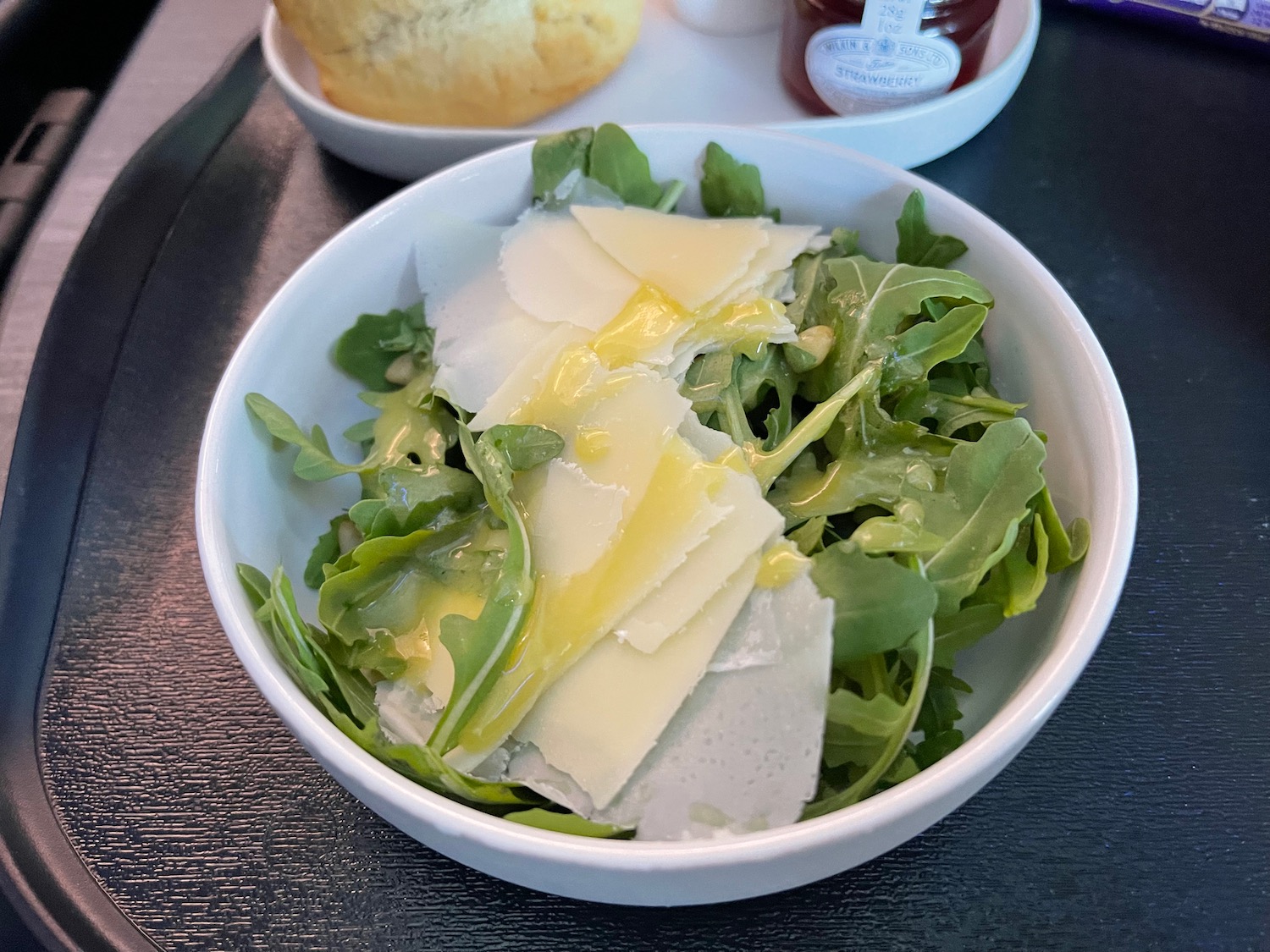 a bowl of salad with cheese and greens