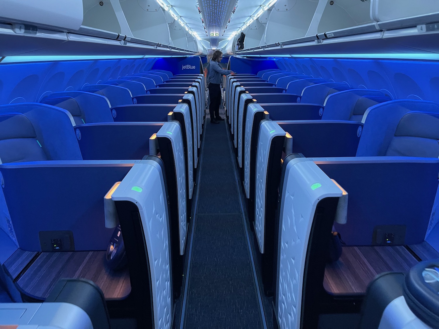 a person standing in the aisle of an airplane