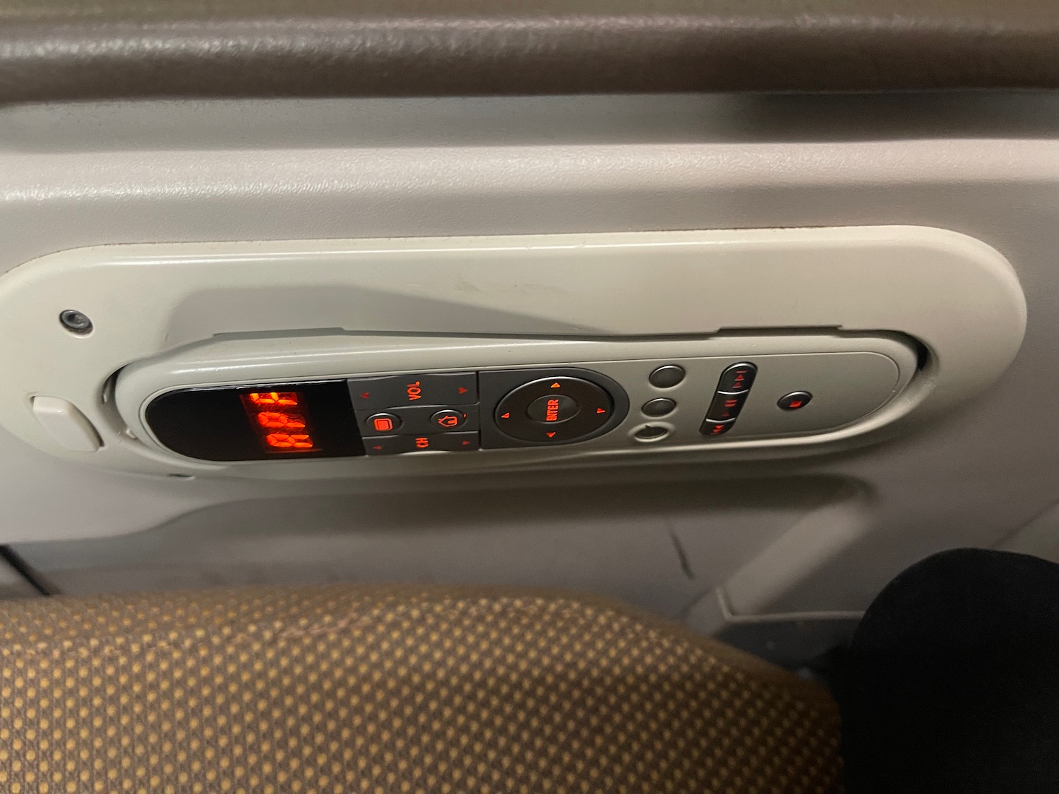 a seat with buttons and lights on