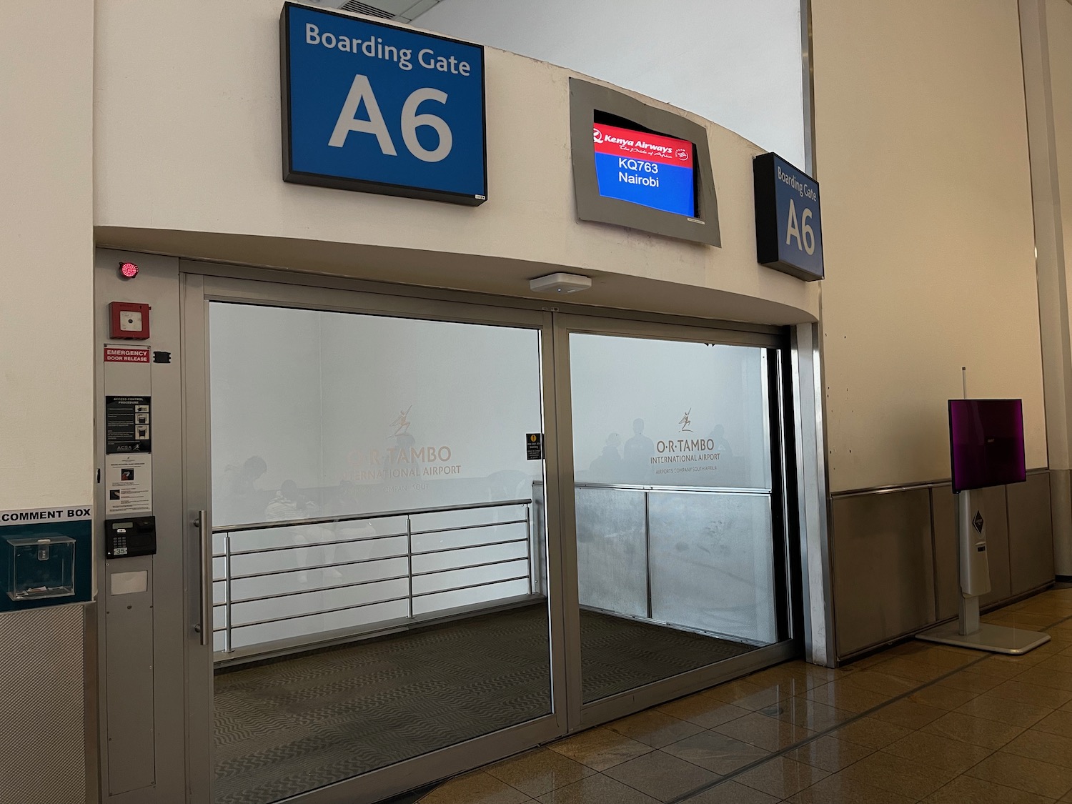 a glass door with a sign on the wall