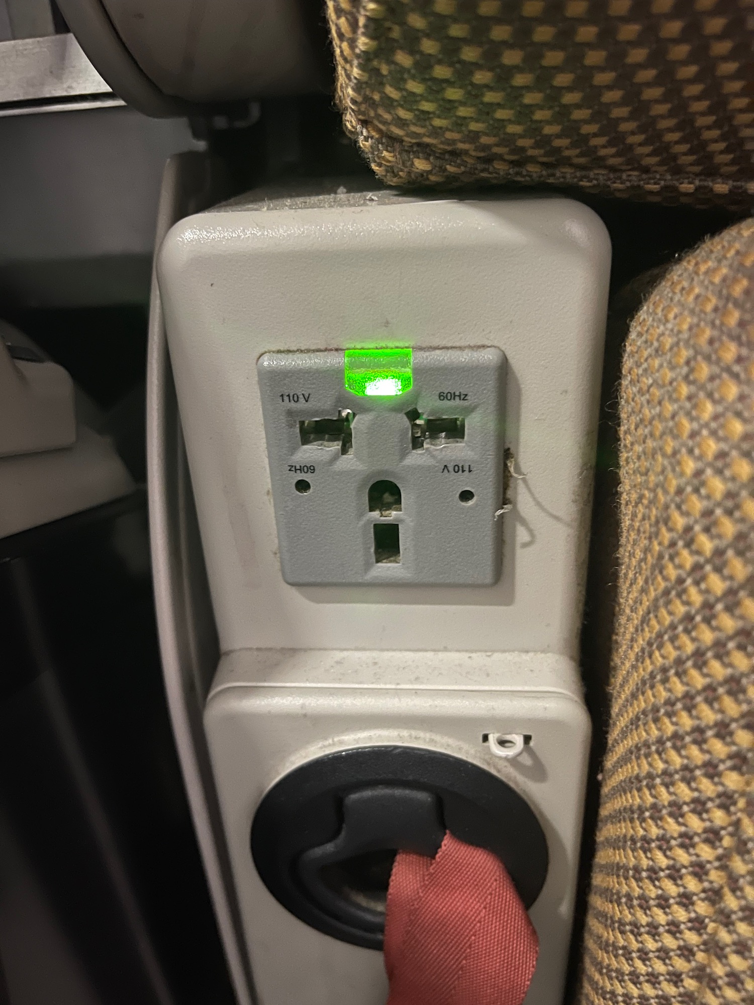 a power outlet with green light